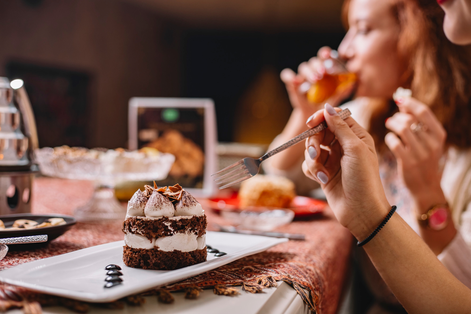 A plated chocolate dessert on a dinner table during an evening meal.
