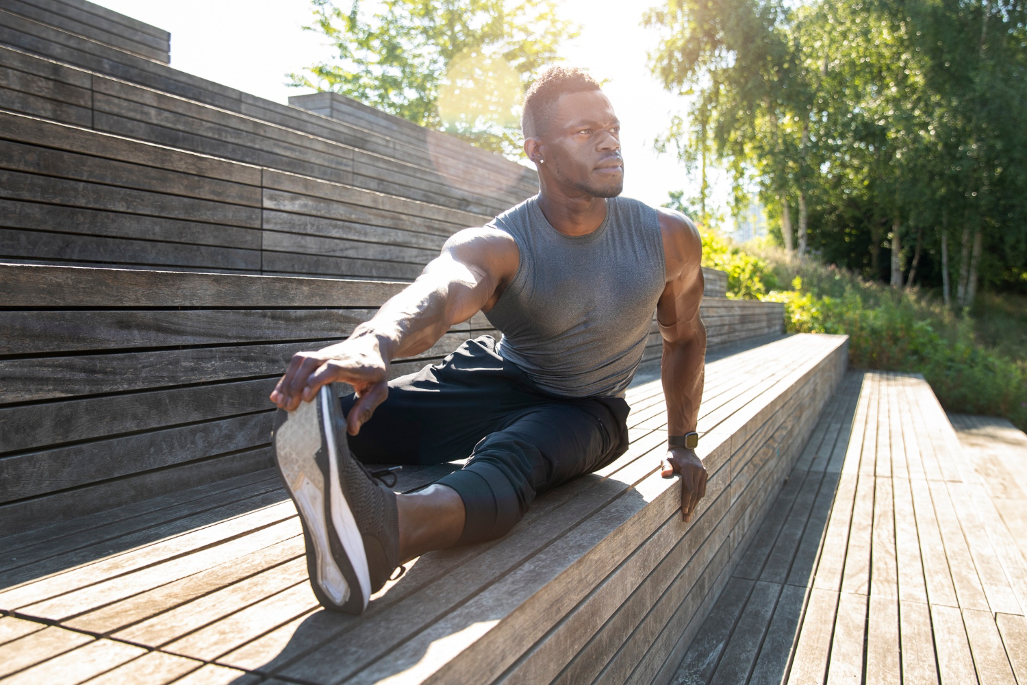 A man stretches outdoors in bright morning sunlight, showing the kind of light and low-intensity movement that can support sleep on rest days.